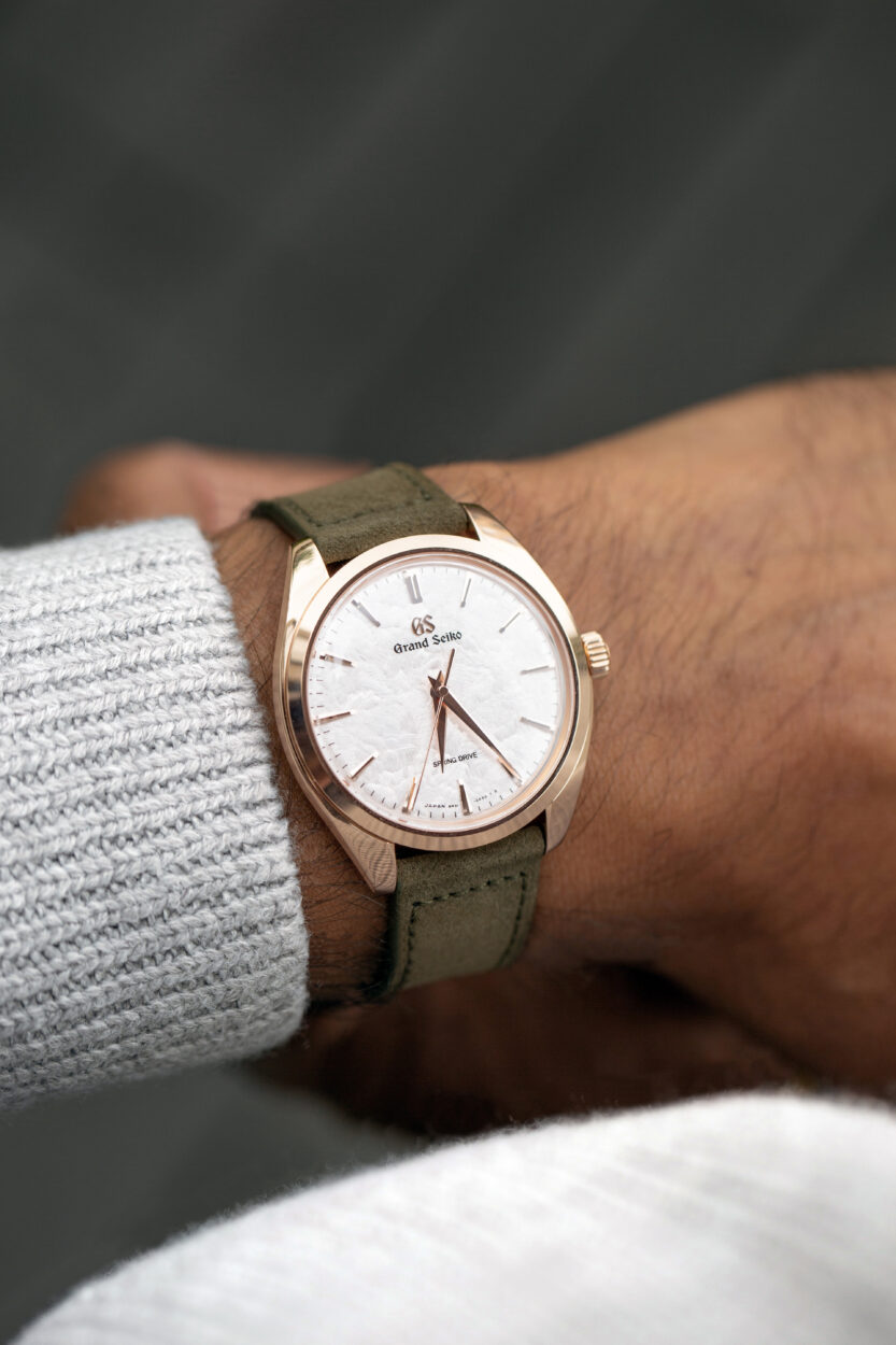 rose gold Grand Seiko on the wrist with ivy green suede molequin strap